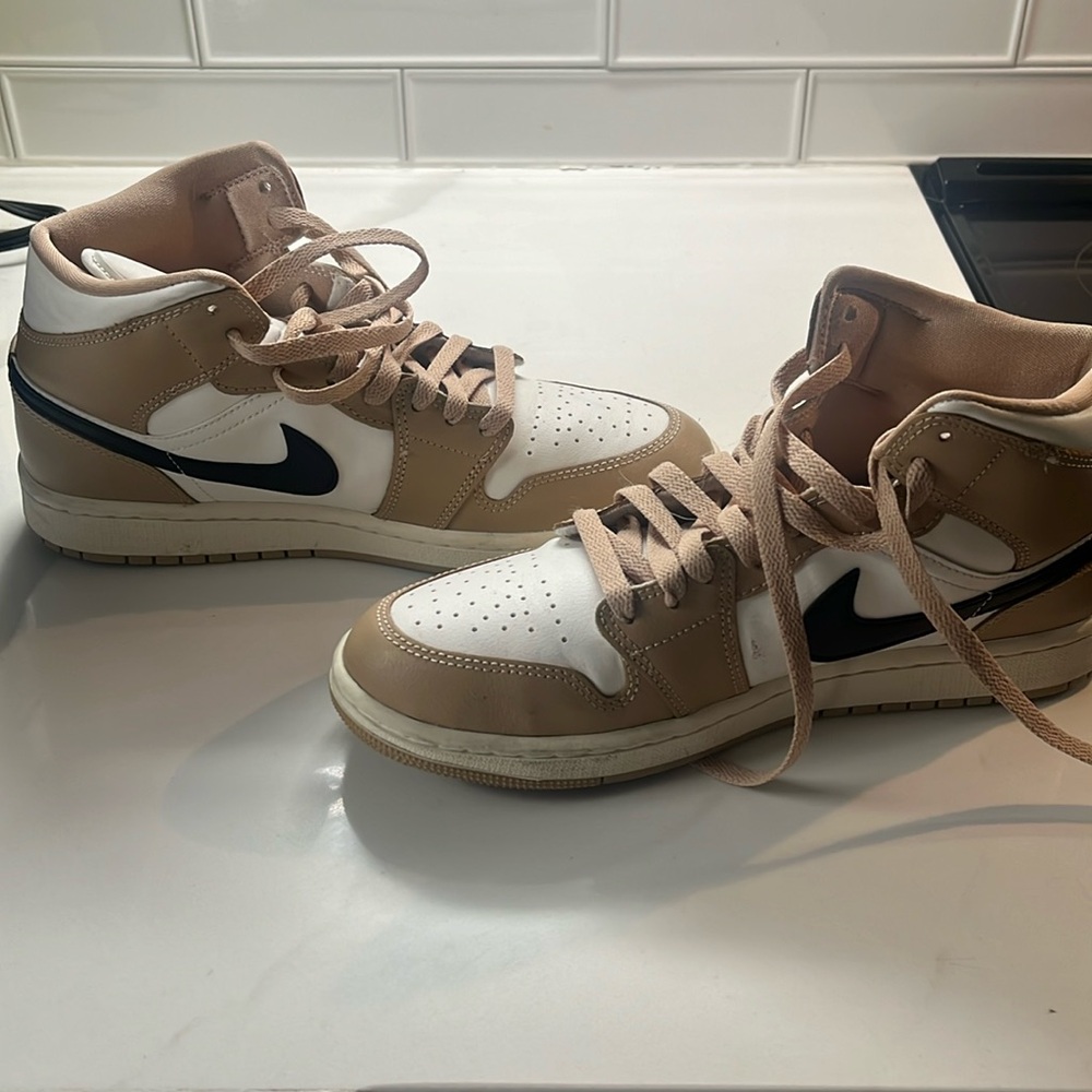 Tan and black Nike air Jordans